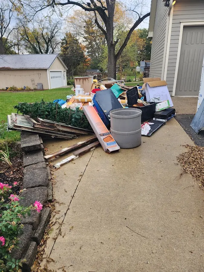 Dumpster being loaded with debris for Estate Cleanout Dumpster Rental in Hampstead